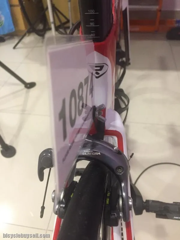 Race number holder clip for rear break caliper